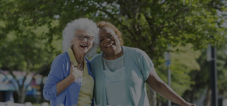 Multiracial senior women standing together outdoors - Featherbed Homecare